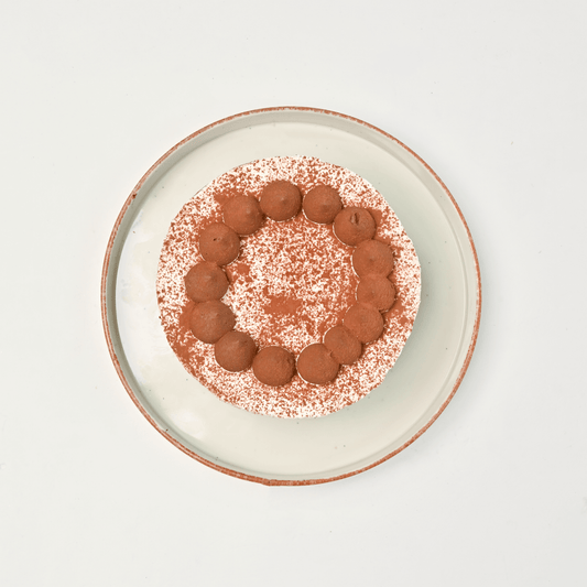 Mini Tiramisu Cake by Lubov—compact round cake with cocoa-dusted top.